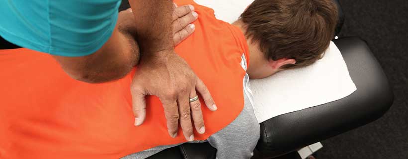 patient receiving drop table chiropractic in Louisville for auto accident injury pain relief